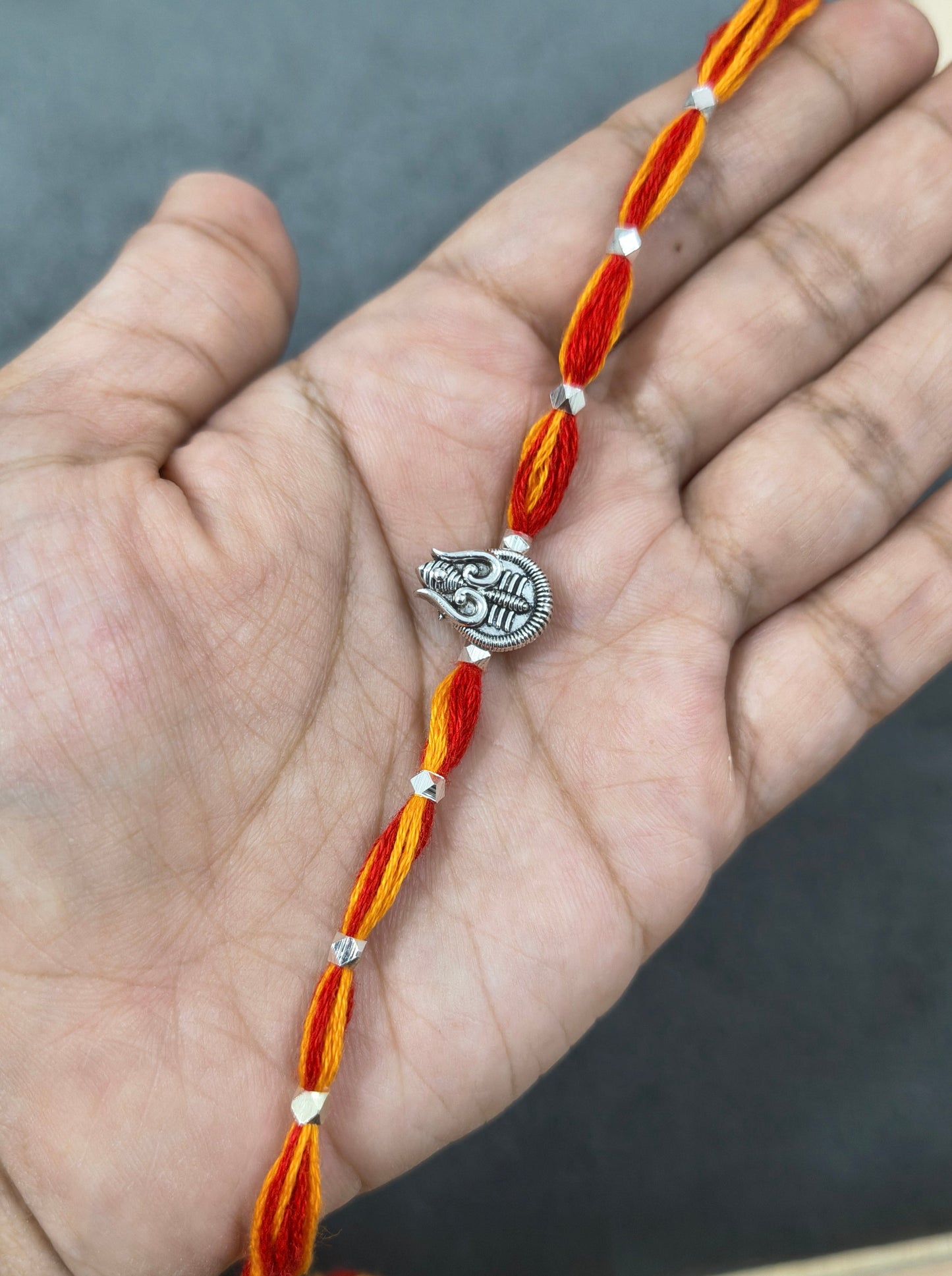 Auspicious Silver Toned Shiv Trishul Rakhi for Brother