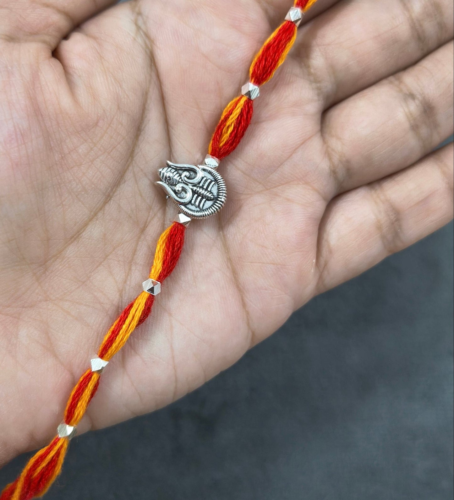 Auspicious Silver Toned Shiv Trishul Rakhi for Brother