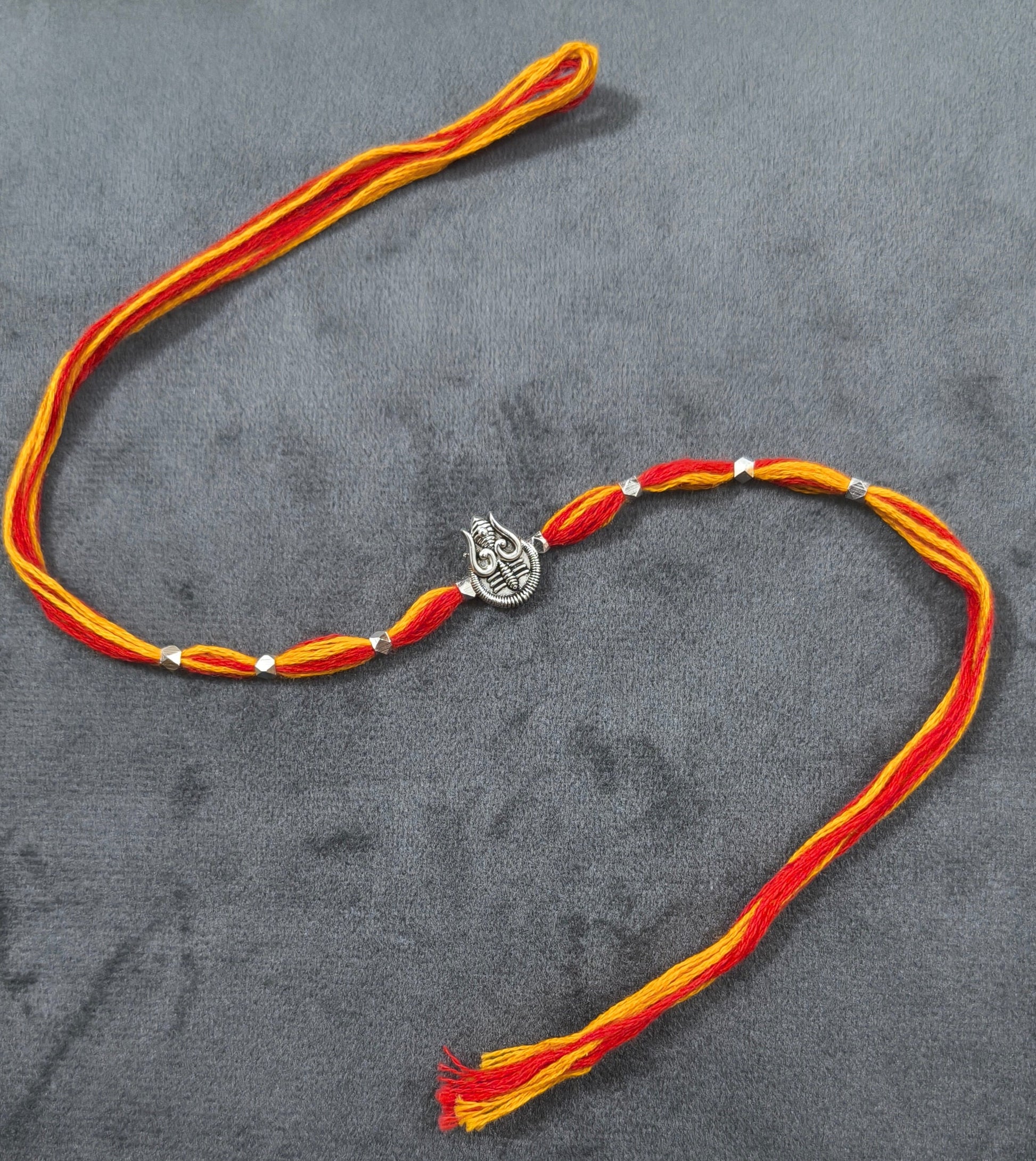 Auspicious Silver Toned Shiv Trishul Rakhi for Brother