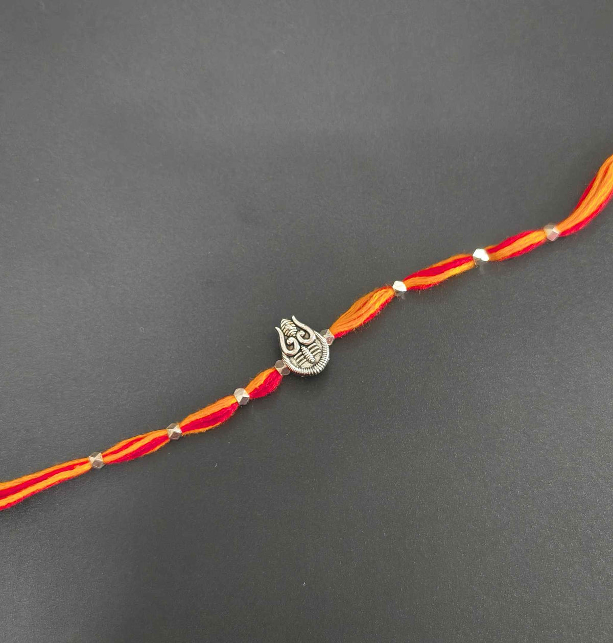 Auspicious Silver Toned Shiv Trishul Rakhi for Brother