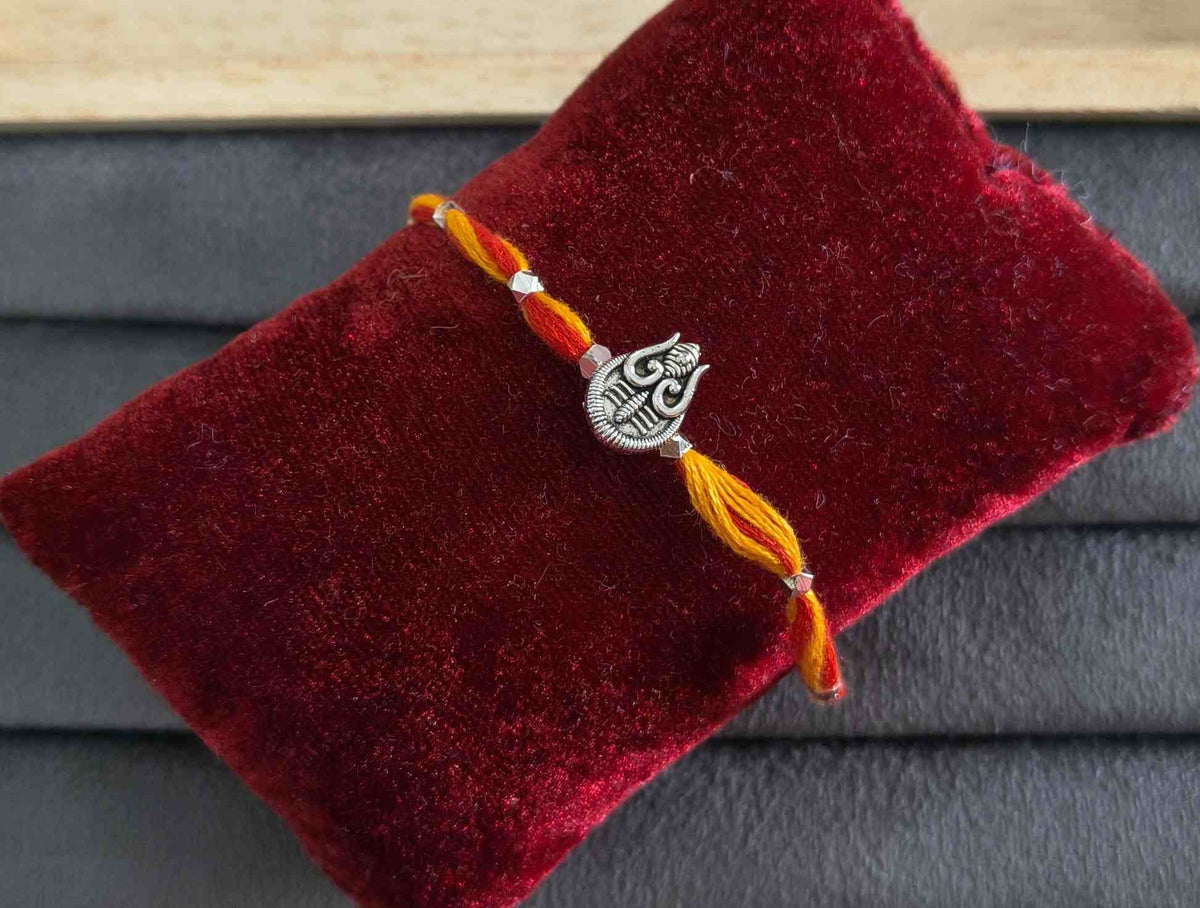 Auspicious Silver Toned Shiv Trishul Rakhi for Brother