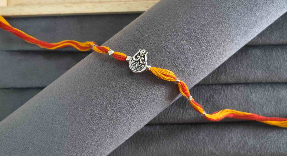 Auspicious Silver Toned Shiv Trishul Rakhi for Brother